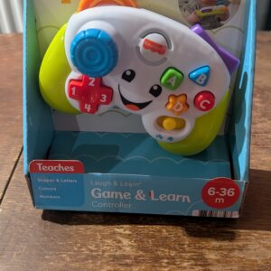 Fisher-Price Laugh & Learn Game & Learn Controller, UK English Version, musical toy with lights and learning content for baby and toddler ages 6-36 months, FWG12